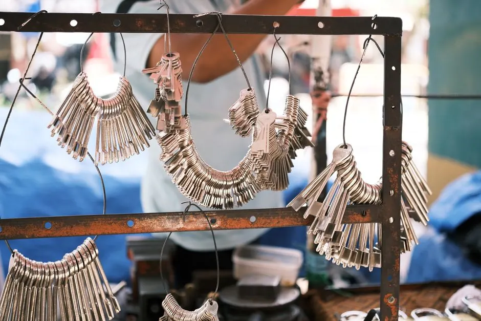Close-up of numerous metal keys arranged on a display in a vibrant outdoor market.